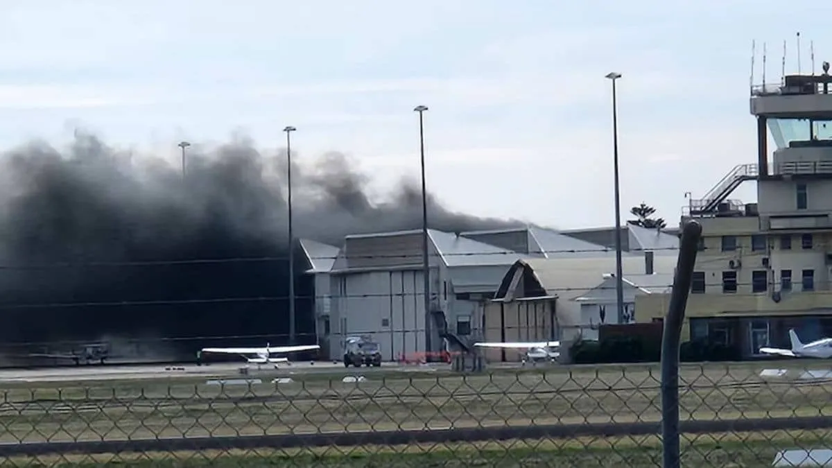 Small plane crash sparks fire and thick smoke at Adelaide airport hangar